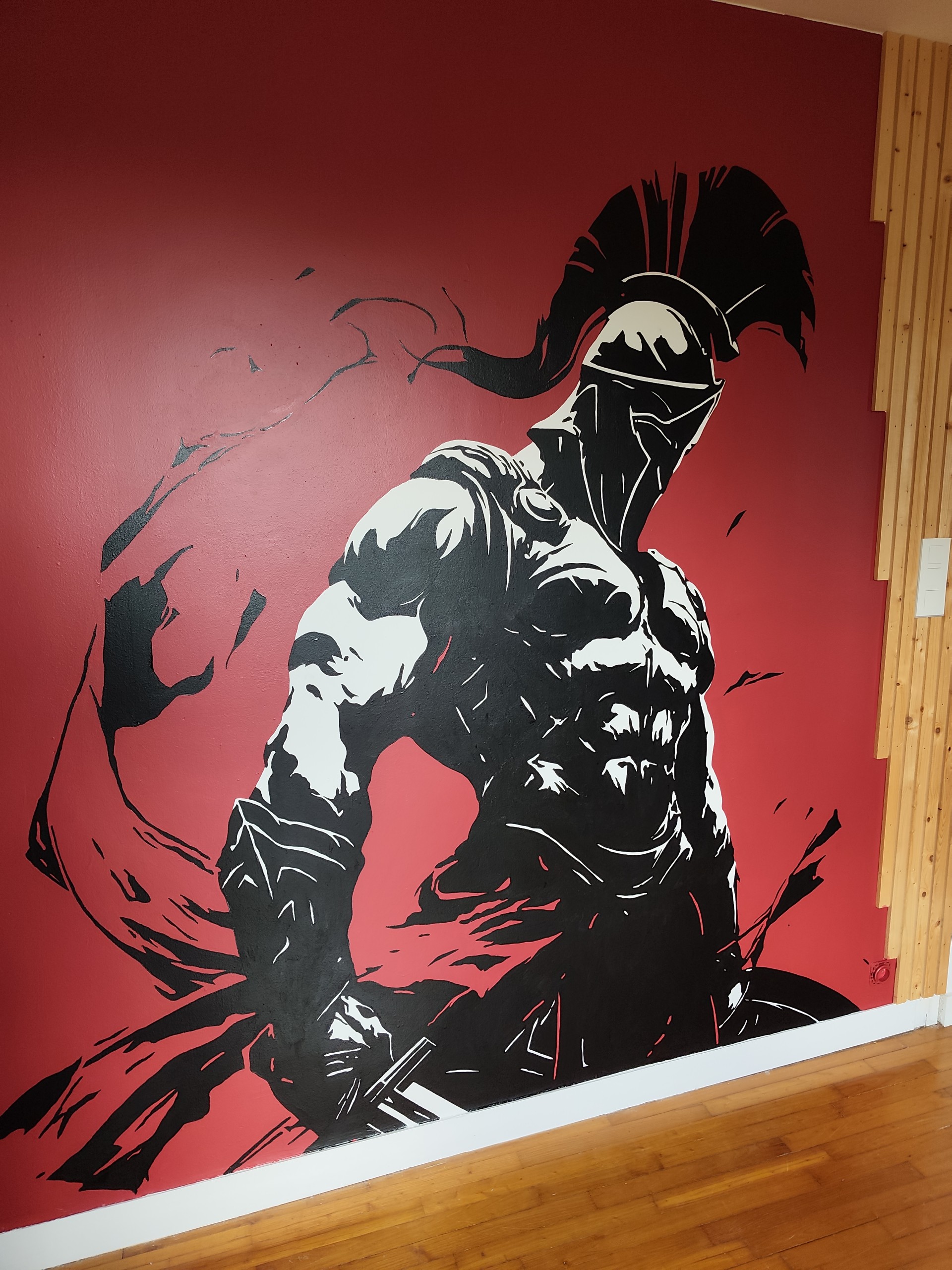 Fresque murale rouge, noire et blanche représentant le dieu Arès
